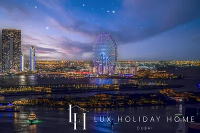 a city skyline with a ferris wheel at night at LUX Iconic Views at The Palm Tower Studio 3 in Dubai