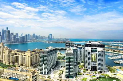 an aerial view of a city with buildings and water at LUX Iconic Views at The Palm Tower Studio 3 in Dubai