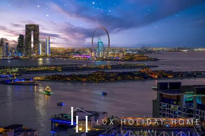 a city skyline with a ferris wheel at night at LUX Iconic Views at The Palm Tower Studio 3 in Dubai