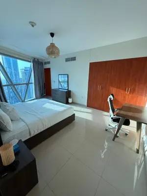 a large bedroom with a bed and a desk and a desk at Damac Park Tower, Luxury 2BR with Stunning City Views in Dubai