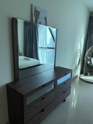 a dresser with a mirror on top of it at Damac Park Tower, Luxury 2BR with Stunning City Views in Dubai