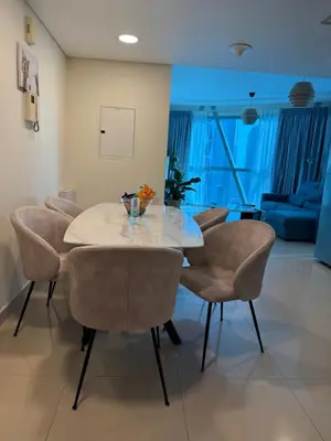 a dining room with a glass table and chairs at Damac Park Tower, Luxury 2BR with Stunning City Views in Dubai