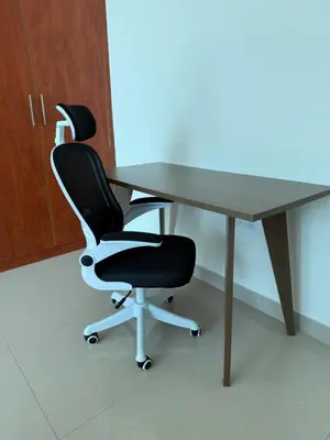 an office desk with two chairs and a table at Damac Park Tower, Luxury 2BR with Stunning City Views in Dubai