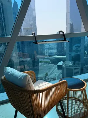 a wicker chair sitting on top of a building at Damac Park Tower, Luxury 2BR with Stunning City Views in Dubai