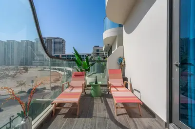 a balcony with chairs and a view of a city at Venetian - Relax in your private pool balcony in Dubai in Dubai
