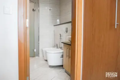 a bathroom with a tub and a toilet and a sink at LIGHT APARTMENT by Design Studio in Dubai