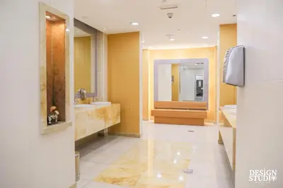 a bathroom with two sinks and two mirrors at LIGHT APARTMENT by Design Studio in Dubai