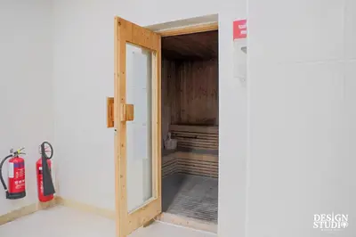 an open door to a room with a fire extinguisher at LIGHT APARTMENT by Design Studio in Dubai