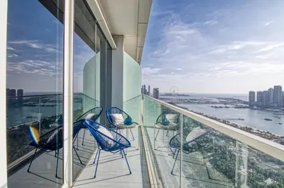a balcony with chairs and a view of the city at GuestReady - Sea view retreat overlooking The Palm in Dubai