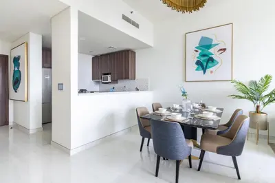 a dining room and kitchen with a table and chairs at GuestReady - Sea view retreat overlooking The Palm in Dubai