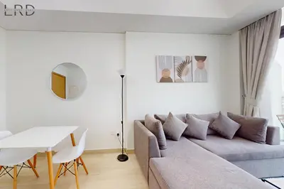 a living room with a couch and a table at Chic 1BR with Canal View in Dubai