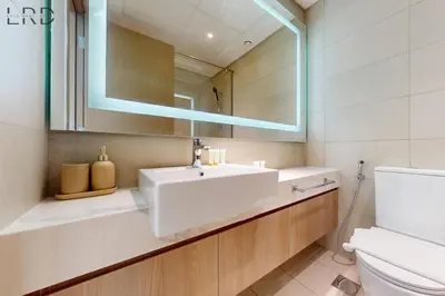 a bathroom with a sink and a mirror at Chic 1BR with Canal View in Dubai