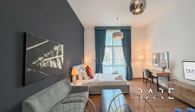 a living room with a couch and a table at Rare Holiday Homes - Mediterranean Cluster - Near Ibn Battuta Mall - Discovery Garden - Building# Med 65 - RG04 in Dubai