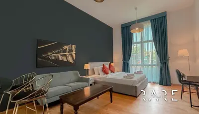 a living room with a couch and a table at Rare Holiday Homes - Mediterranean Cluster - Near Ibn Battuta Mall - Discovery Garden - Building# Med 65 - RG04 in Dubai