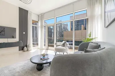 a living room with a couch and a table at Silkhaus Lavish 2BDR in Bay Square at Prime location in Dubai