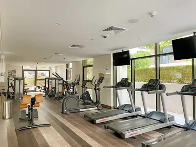 a gym with several tread machines in a room at Silkhaus Luxurious 3BR with Maid Room in Dubai Hills in Dubai