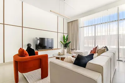 a living room with two couches and a tv at Silkhaus Luxurious 3BR with Maid Room in Dubai Hills in Dubai
