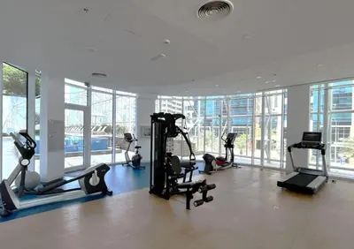 a gym with treadmills and exercise equipment in a building at Remarkable one BR in Business Bay with Canal View in Dubai