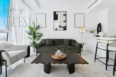 a living room with a green couch and a table at Remarkable one BR in Business Bay with Canal View in Dubai