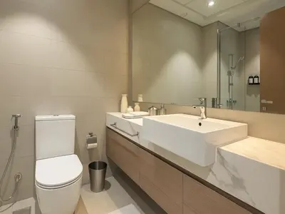 a bathroom with a white toilet and a sink at Cozy New Studio Heart of Al Furjan in Dubai