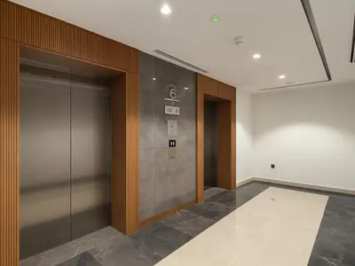an elevator in an office building with a glass door at Cozy New Studio Heart of Al Furjan in Dubai