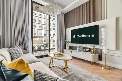 a living room with a couch and a tv at Luxury at Its Finest, 2BR with Private Indoor Pool in Dubai