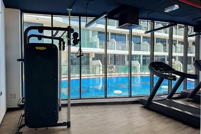 a gym with a swimming pool in a building at Luxury at Its Finest, 2BR with Private Indoor Pool in Dubai