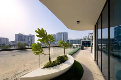 a building with palm trees on the roof at Luxury at Its Finest, 2BR with Private Indoor Pool in Dubai