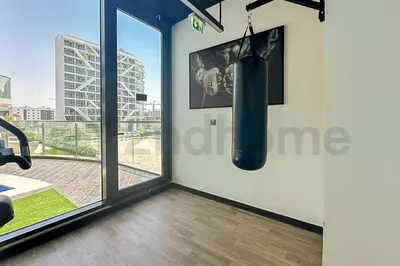 a room with a punching bag hanging on the wall at Luxury at Its Finest, 2BR with Private Indoor Pool in Dubai