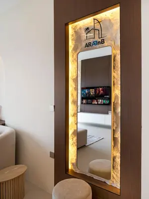 a mirror in front of a room with a refrigerator at Spacious, Modern Chic 2 BDR Apartment in Prime Downtown Location in Dubai