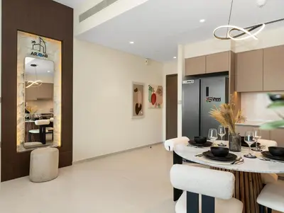 a kitchen and dining room with a table and chairs at Spacious, Modern Chic 2 BDR Apartment in Prime Downtown Location in Dubai
