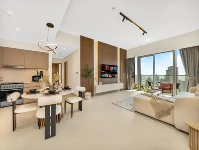 a living room with a kitchen and a dining room at Spacious, Modern Chic 2 BDR Apartment in Prime Downtown Location in Dubai