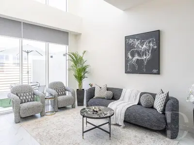 a living room with a couch and chairs and a table at Cozy house suitable for family in Dubai
