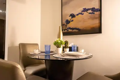 a table in a dining room with a painting at Mejestic Studio in Dubai