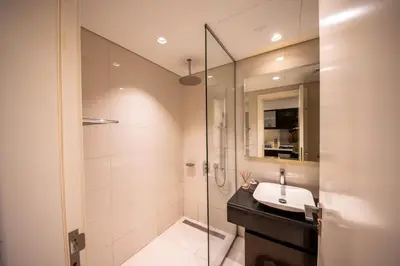 a bathroom with a sink and a glass shower at Mejestic Studio in Dubai