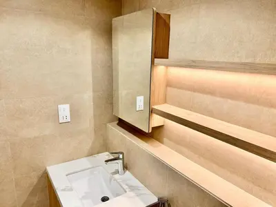 a bathroom with a sink and a mirror at Homes2Retreat - Modern Comforts 1 BR in Liva Lush Living in Dubai