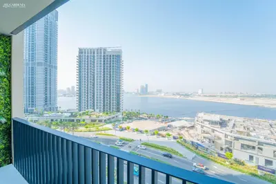 a balcony with a view of the ocean and buildings at Gardenia Suites Creek Harbour, 2 Bedroom Stylish Apartment with Creek Views in Dubai