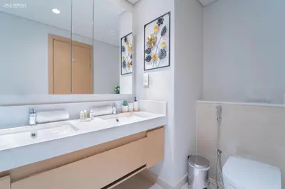 a bathroom with a sink and a mirror at Gardenia Suites Creek Harbour, 2 Bedroom Stylish Apartment with Creek Views in Dubai