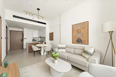 a living room with a couch and a table at VayK - Stylish Bright 1BR in JVC in Dubai