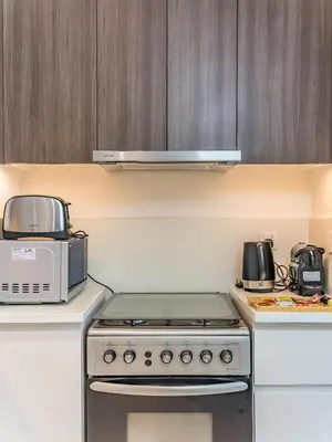a kitchen with a stove and a microwave at Stylish Dubai Hills Retreat 1BR-Park Heights 2 T2 in Dubai