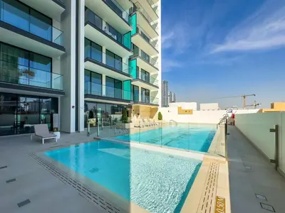 a swimming pool in the middle of a building at DAYF-LAV Brand New Apartment with Balcony in JVC in Dubai