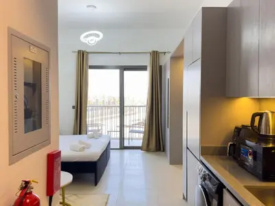 a small room with a bed and a balcony at Stylish Studio Fast Wi-Fi 5 Min to Business Bay in Dubai