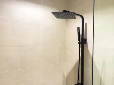 a shower with a shower head in a bathroom at Stylish Studio Fast Wi-Fi 5 Min to Business Bay in Dubai