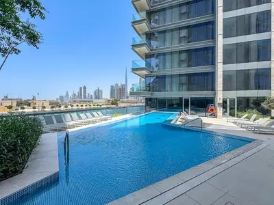 a swimming pool in front of a building at Stylish 1 BR in Canal Front with Pool and Gym Access in Dubai
