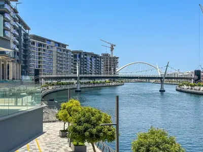 a view of a river with a bridge and buildings at Stylish 1 BR in Canal Front with Pool and Gym Access in Dubai