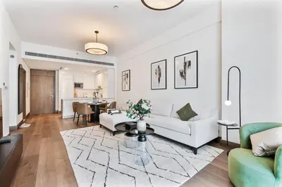 a living room with a couch and a table at Stylish 1 BR in Canal Front with Pool and Gym Access in Dubai