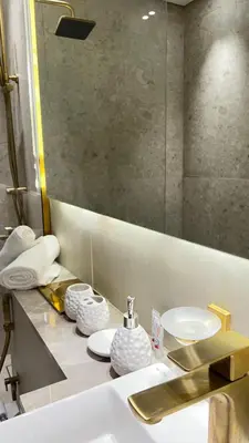 a bathroom with a sink and a mirror at Luxury Apartment in Binghatti Amber in Dubai