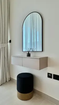 a room with a mirror and a black stool at Luxury Apartment in Binghatti Amber in Dubai