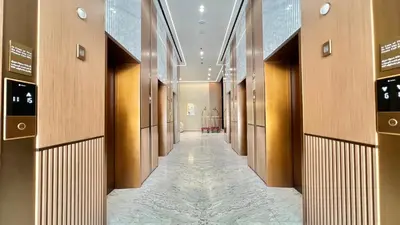 a hallway in a building with wooden walls and a long corridor at Luxury Apartment in Binghatti Amber in Dubai