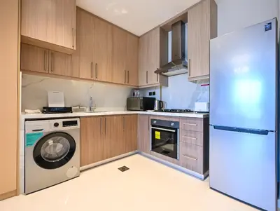 a kitchen with a washing machine and a refrigerator at Luxury Studio Near Burj Khalifa in Dubai
